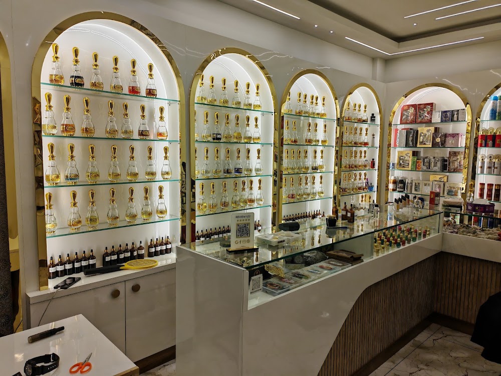 Inside the Royal Hayat boutique — white marble counters and golden arched shelves lined with attar bottles